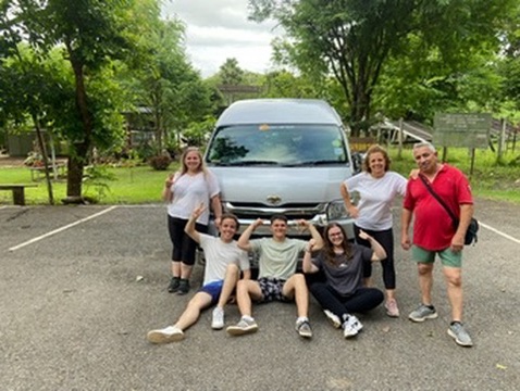Tourist group photo in front of a Thai temple
